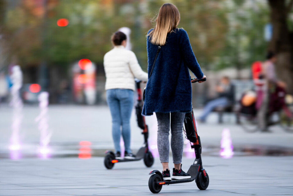 People riding e-scooters. Paris reviews banning rental e-scooters after pedestrian death