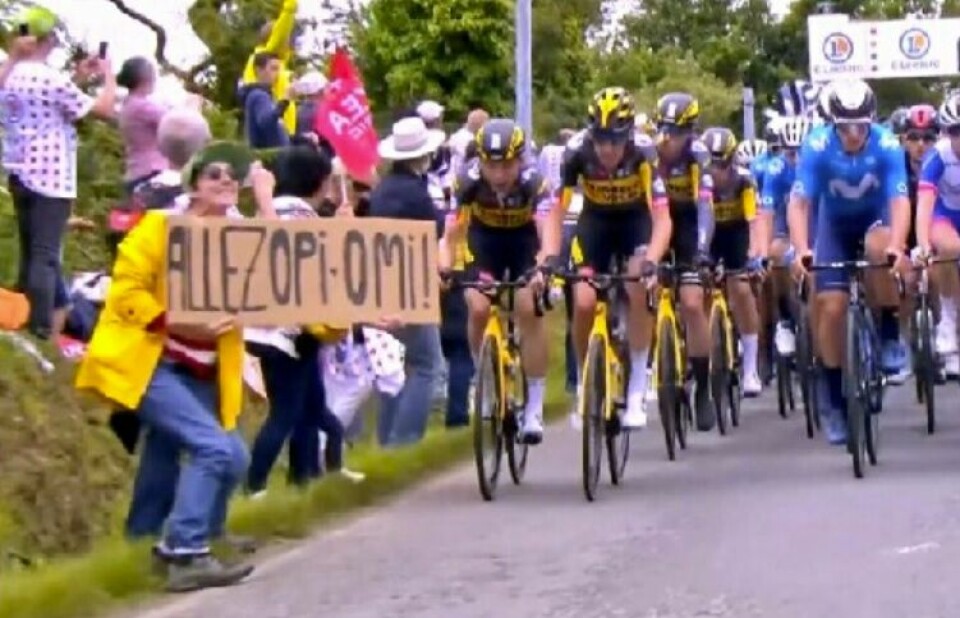 A photo of the woman holding up the sign at the Tour de France just before the crash. Tour de France crash: Authorities search for woman who caused pileup