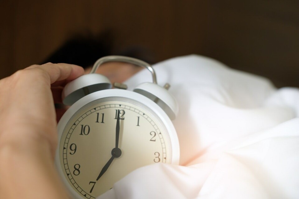 Acharaprn Kamornboonyarush / Pexels / Pexels License A hand holding a clock in bed covers. French study: Less than six hours sleep at 50+ increases dementia risk