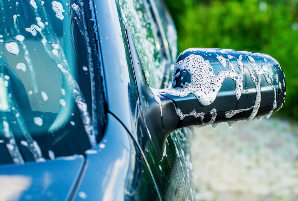 An image of a car wingmirror being washed