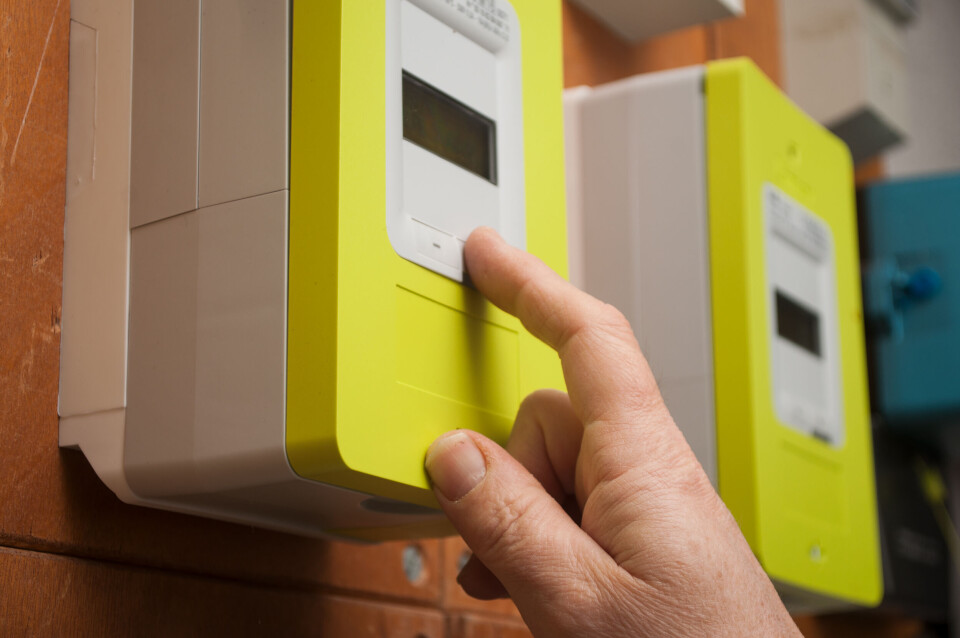 NeydtStock / Shutterstock Closeup of woman’s hand on smart electricity meter