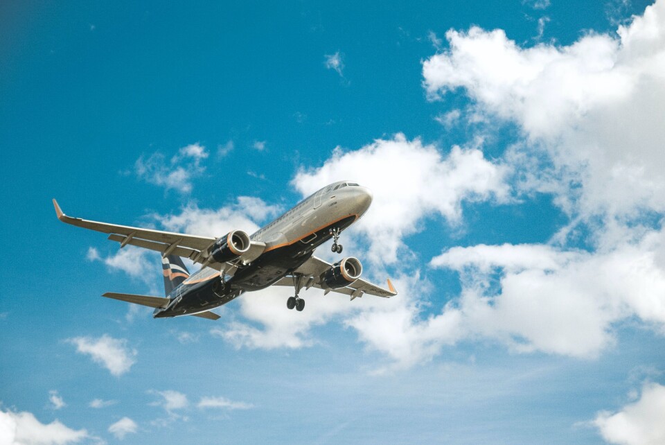 Plane flying through blue sky and clouds. France to impose semi-lockdown so will travel within EU now stop?