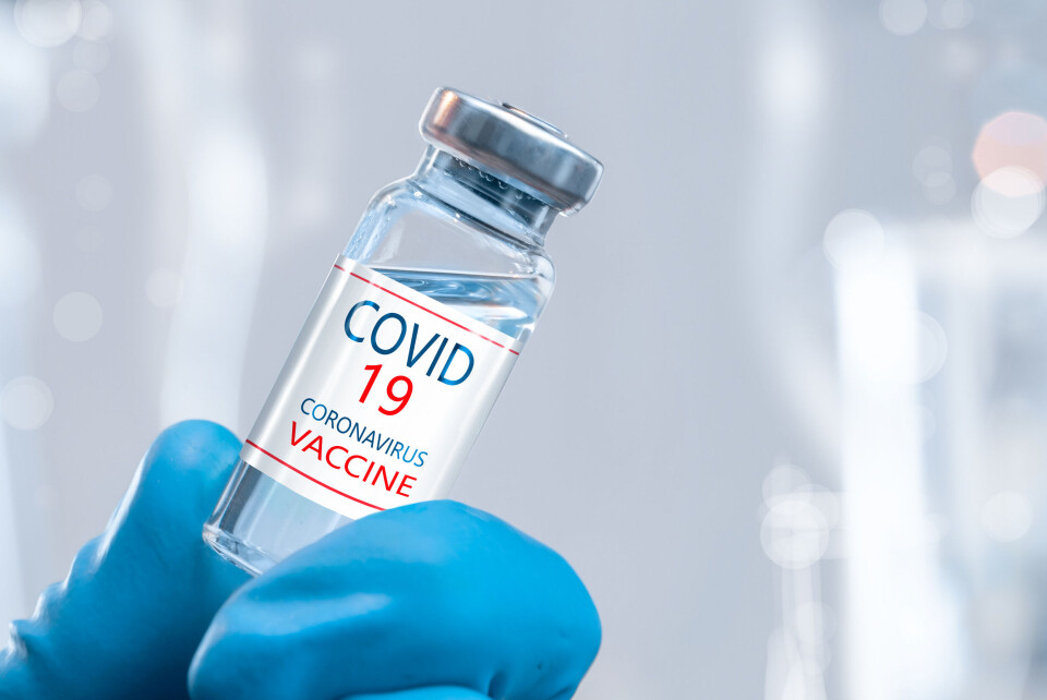 PalSand / Shutterstock A gloved hand holding a vial of Covid vaccine