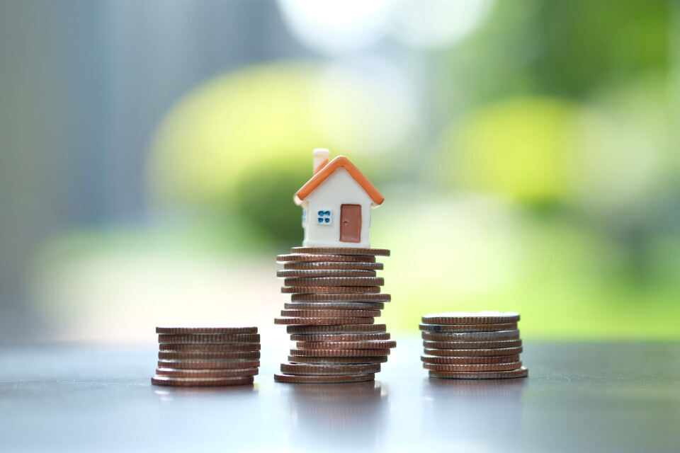 A model house on a pile of coins