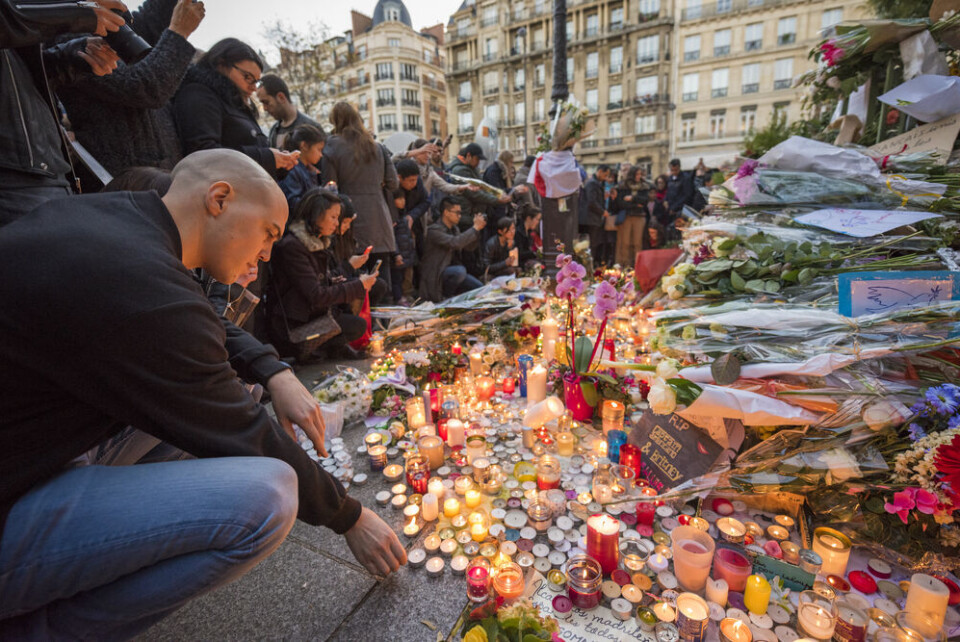 People pay tribue to victims of the 2015 Paris attacks