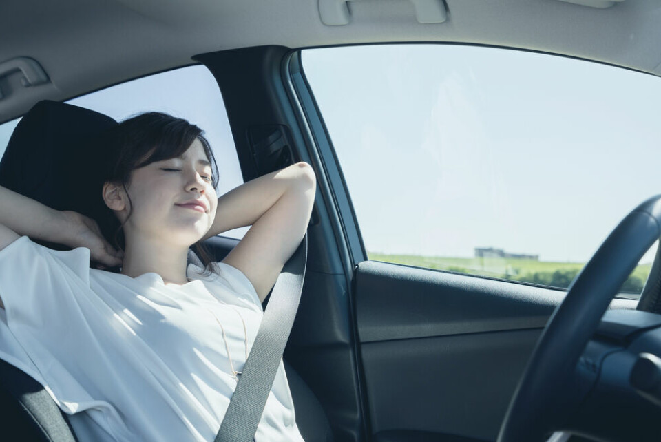 Woman relaxing in self-drive car. France first EU country to adapt its highway code for self-drive cars