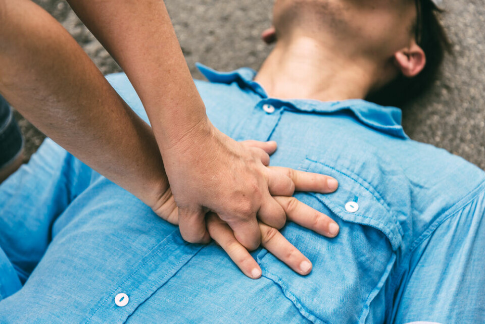 Person giving CPR to a man. French app alerts nearby volunteer first aiders in health emergencies