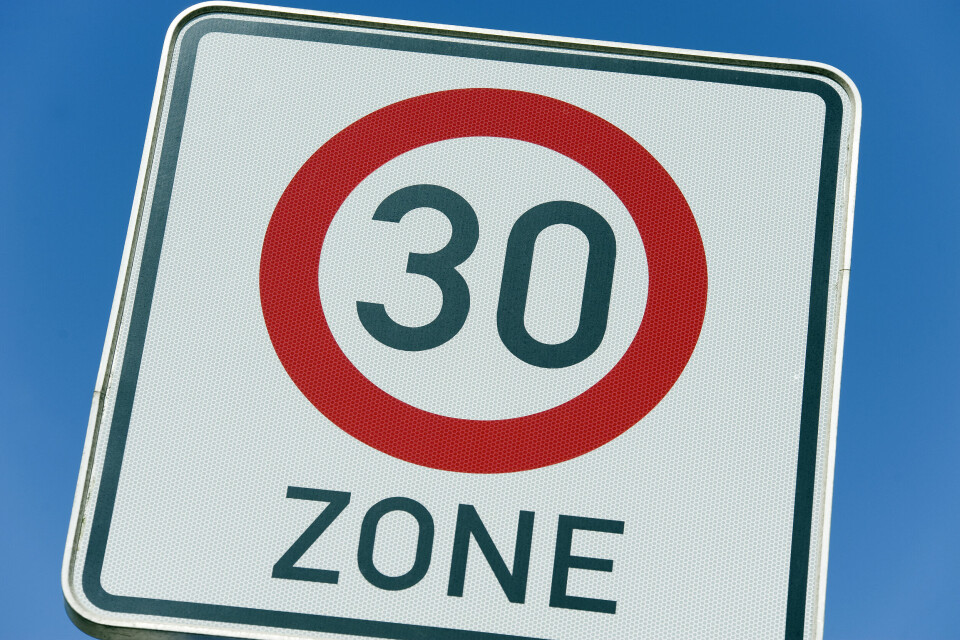 A road sign reading 30kph and the word ZONE, with blue sky behind.
