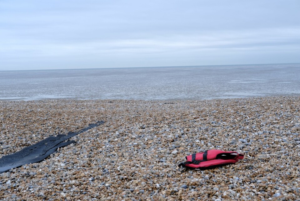 An image of a life jacket left abandoned on a pebbly English beach