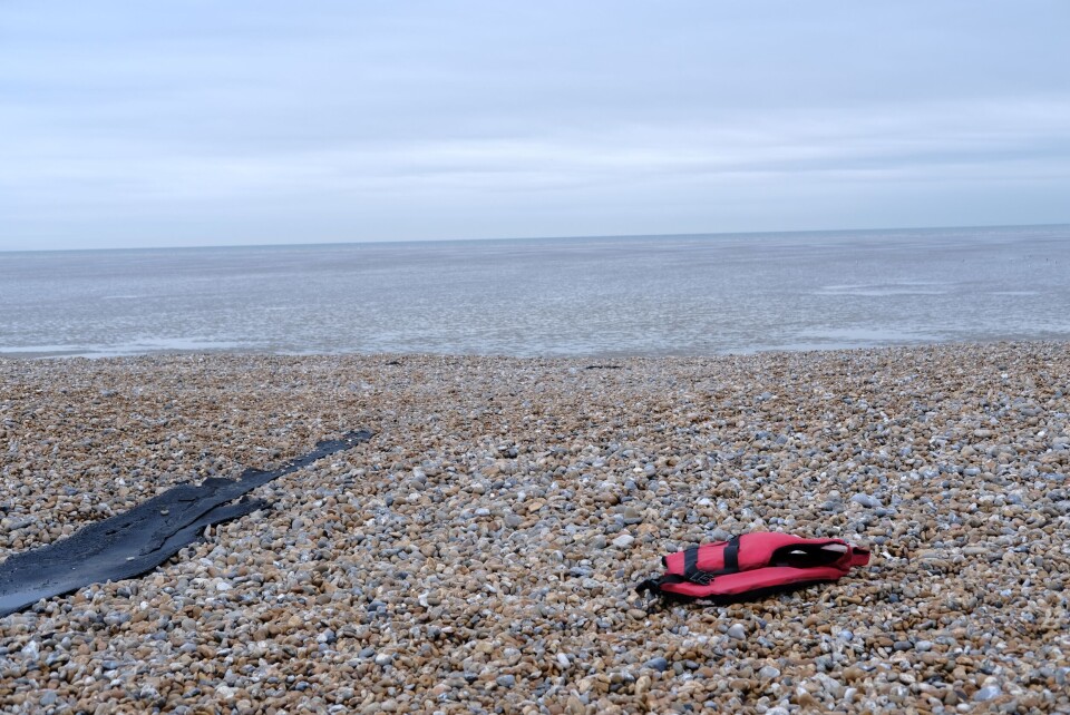 An image of a life jacket left abandoned on a pebbly English beach