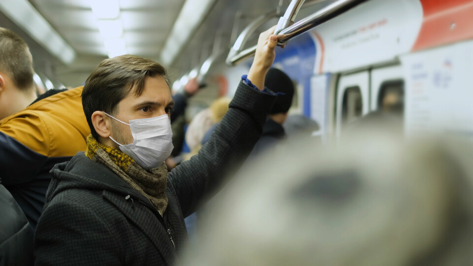 A man wearing a mask while travelling