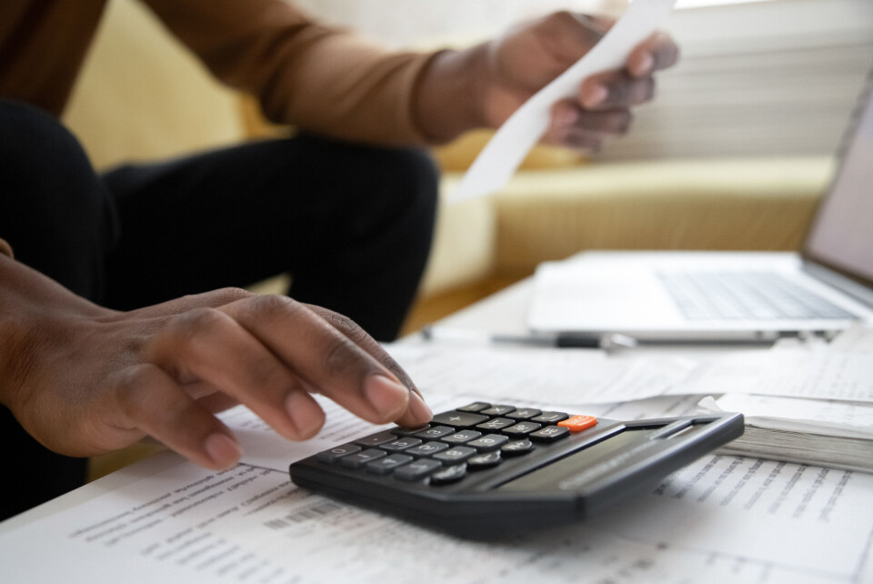 fizkes / Shutterstock Masculine hands sort through official papers with a calculator