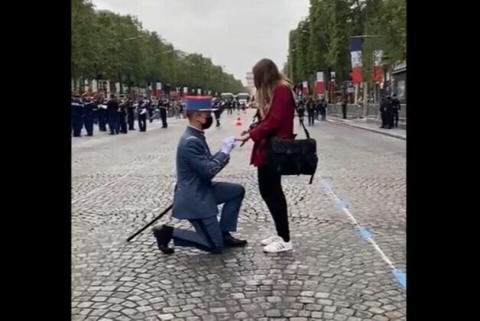 A young cadet proposing to his girlfriend on Paris' Champs-Élysées