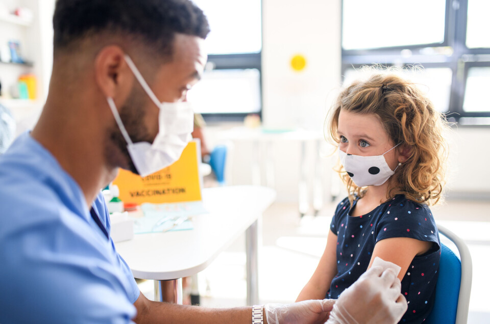 Halfpoint / Shutterstock An image of a small girl with a doctor, who is wiping her arm before giving her a vaccination