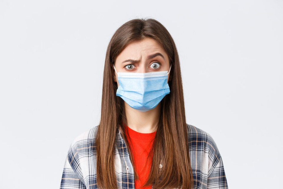 Mix and Match Studio / Shutterstock A woman with a mask looking confused