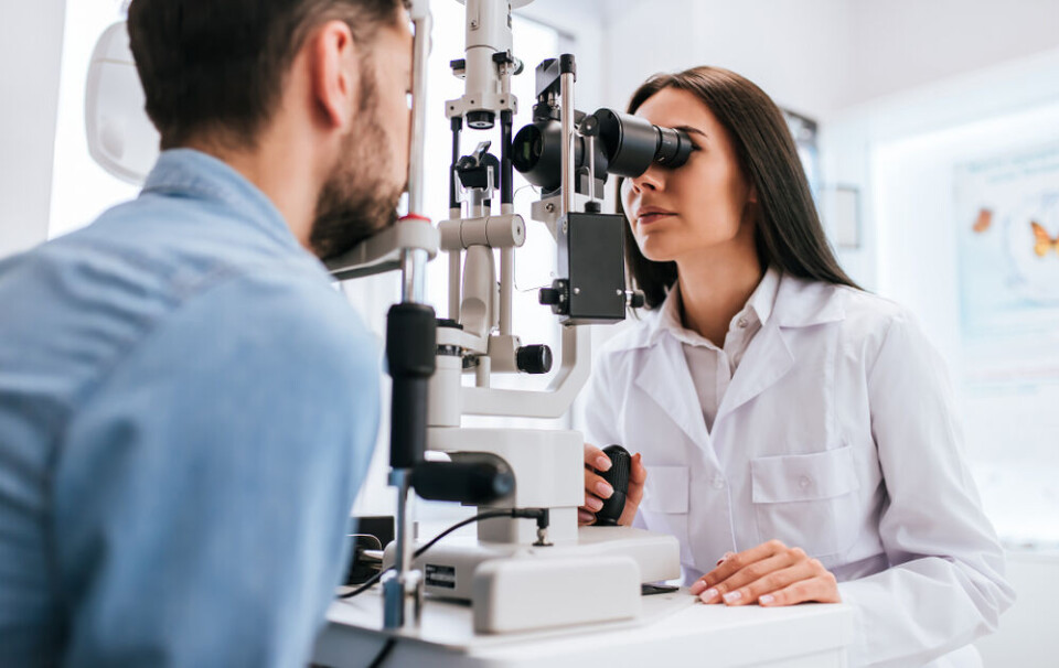 A ophthalmologist checks a patient's eyes