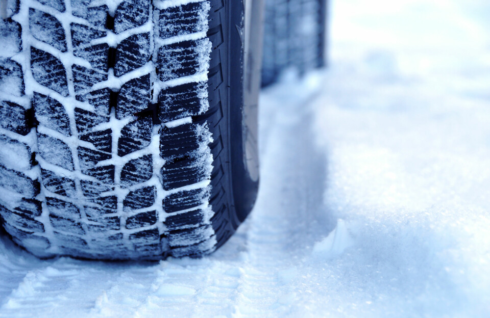 An image of a winter tyre driving through snow