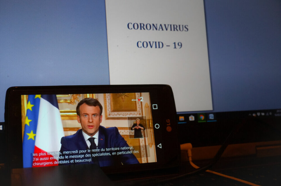 President Emmanuel Macron making a speech being watched on a screen. President Macron takes to TikTok to answer Covid-19 vaccine questions
