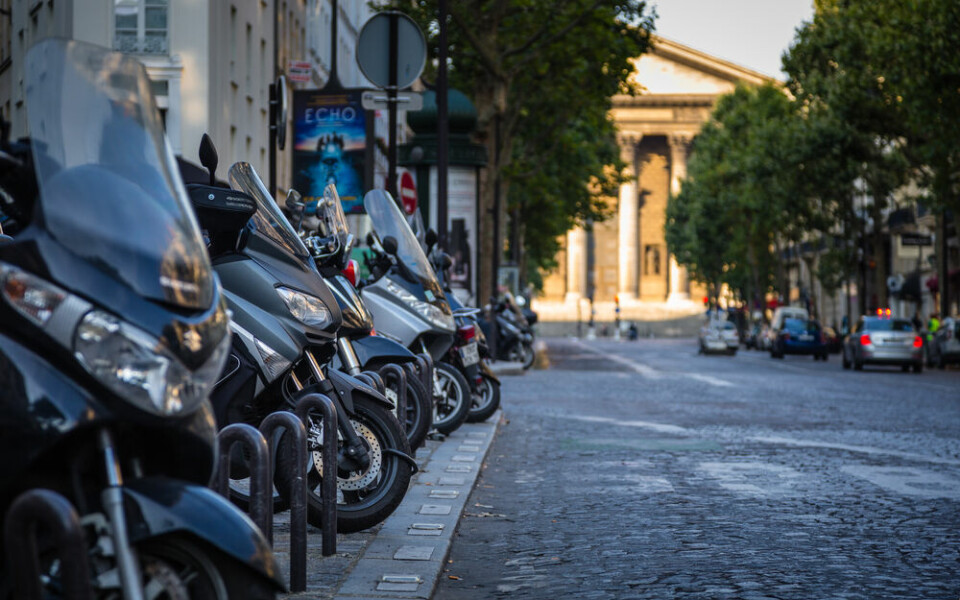 Motorbikes parked on a Paris street. Paris street parking fees set to rise 50% and motorbikes must pay too