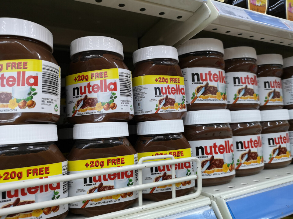 Jars of Nutella chocolate spread on a supermarket shelf, showing a label reading +20g FREE