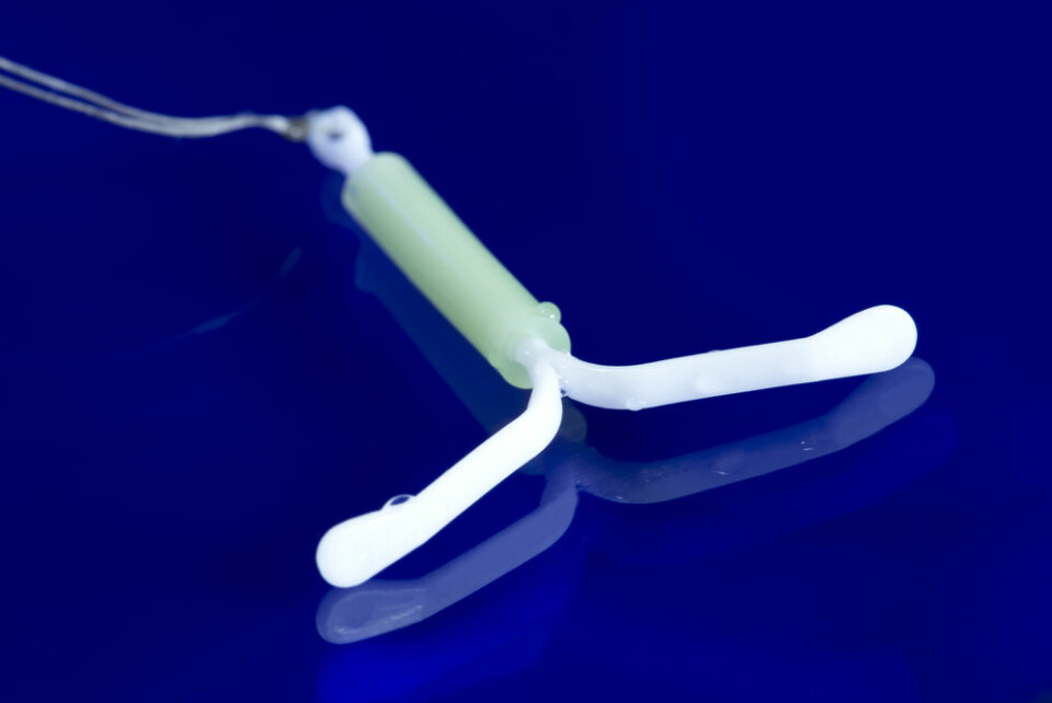 A contraceptive coil on a blue background. 40,000 women in France have potentially faulty contraceptive coils