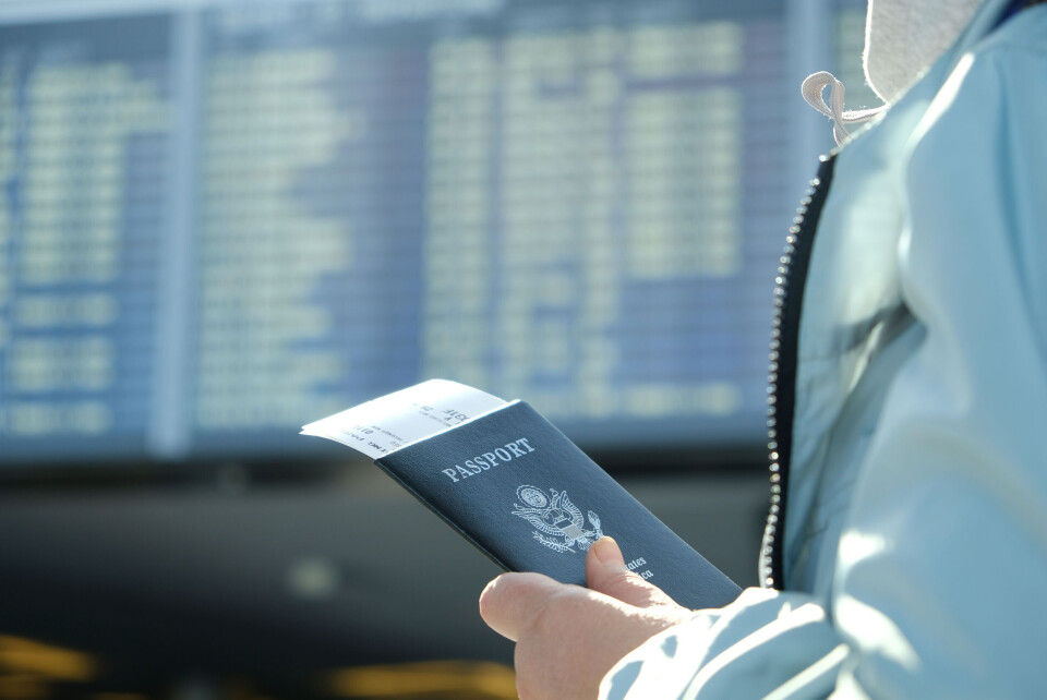 Fotinia / Shutterstock A woman at an airport with a US passport
