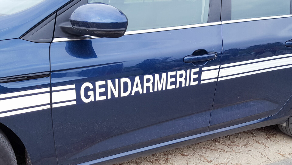 Gendarmerie sign on a dark blue gendarme car
