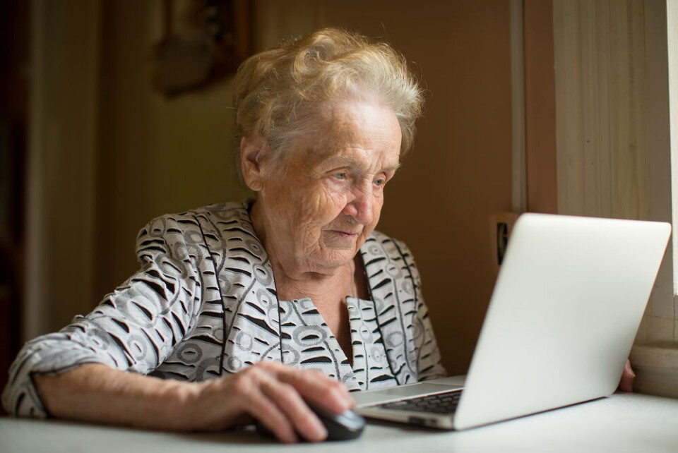 De Visu / Shutterstock An elderly woman using a computer. People vaccinated early struggle to get QR code for French health pass