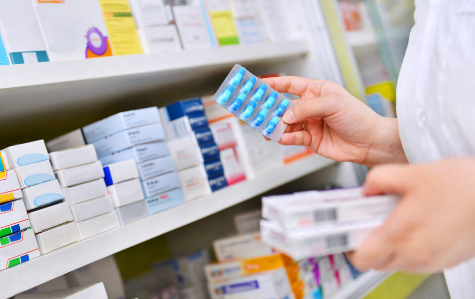 i viewfiner / Shutterstock A pharmacist holding medicines in a pharmacy