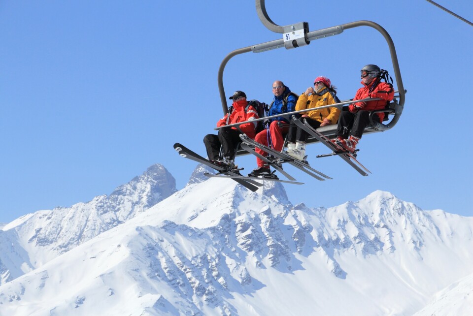 Four people on a ski lift in the Galibier-Thabor station in France