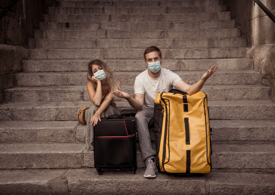 Sam Wordley / Shutterstock Confused travellers with masks to protect against Covid-19