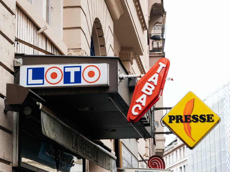 Signage outside a tabac shop in France, reading Tabac, Loto, and Presse
