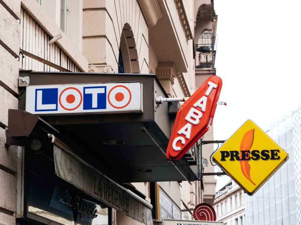 Signage outside a tabac shop in France, reading Tabac, Loto, and Presse