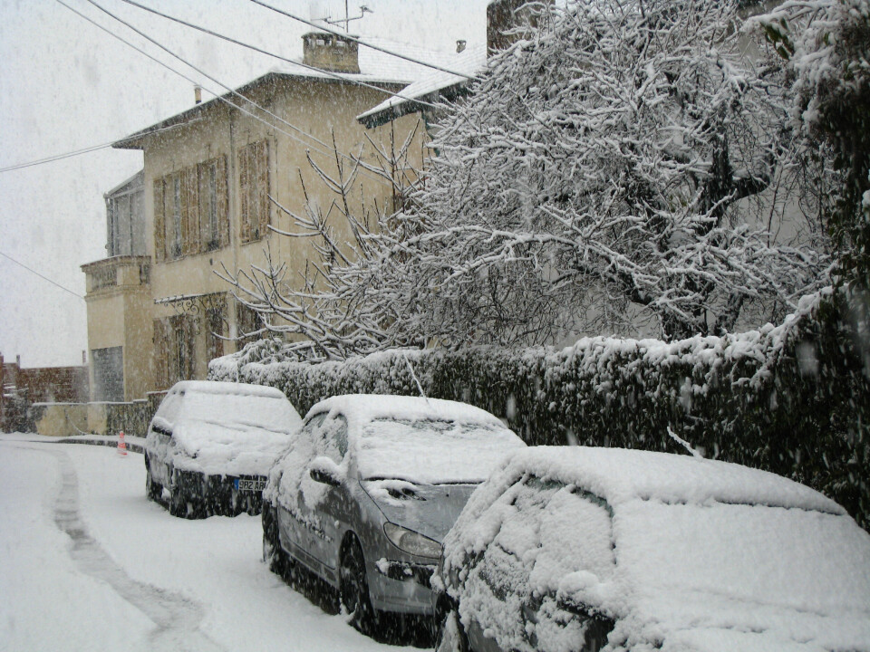 A house and cars covered in snow in the Alpes-Maritimes, France