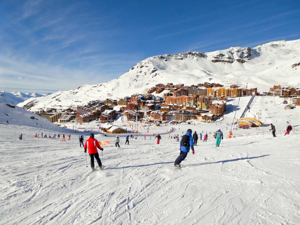 Skiers head down a slope in Val Thorens