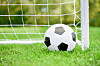 Football on green grass in front of white goal with net. Amateur football in France: Covid-19 health pass now required