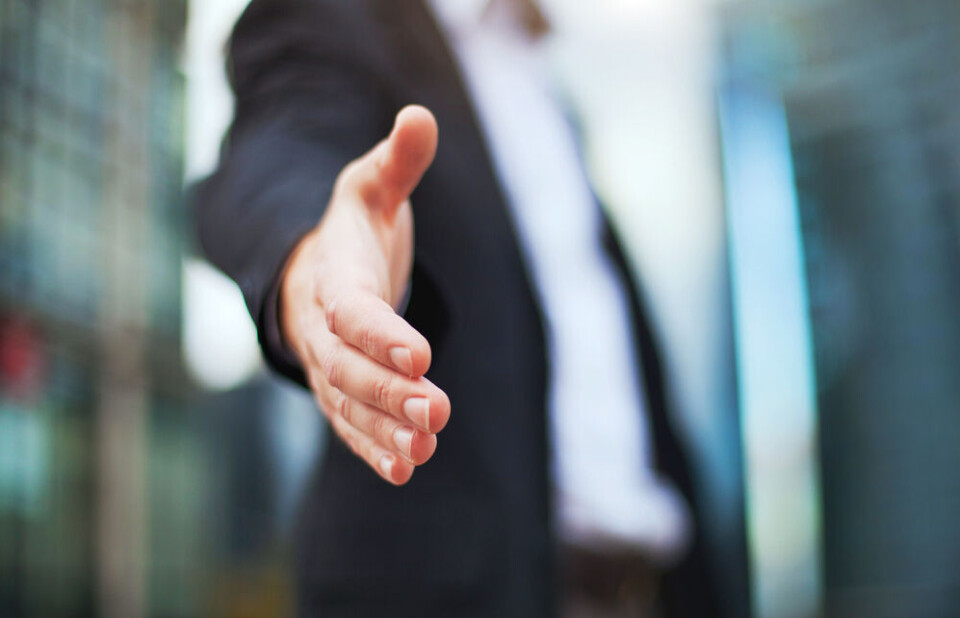 A view of a man holding our his hand for a handshake