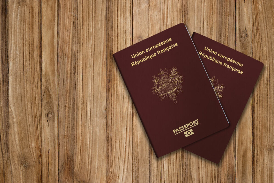 Two French passports on a wooden table