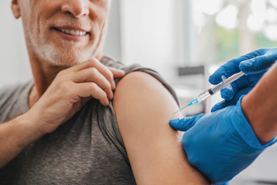 An older man having a vaccination in one arm