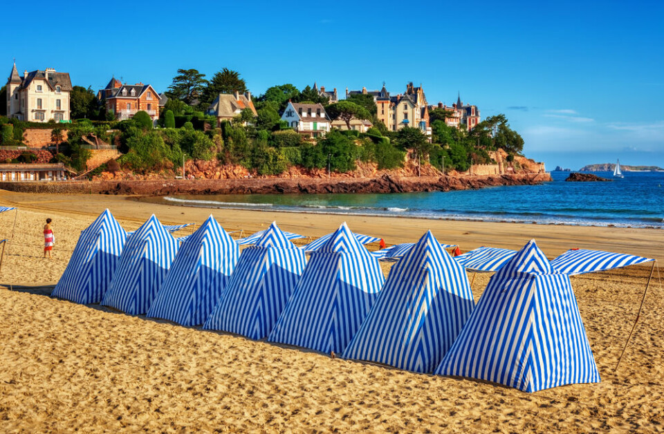 A Brittany beach with traditional Breton blue and white beach tents
