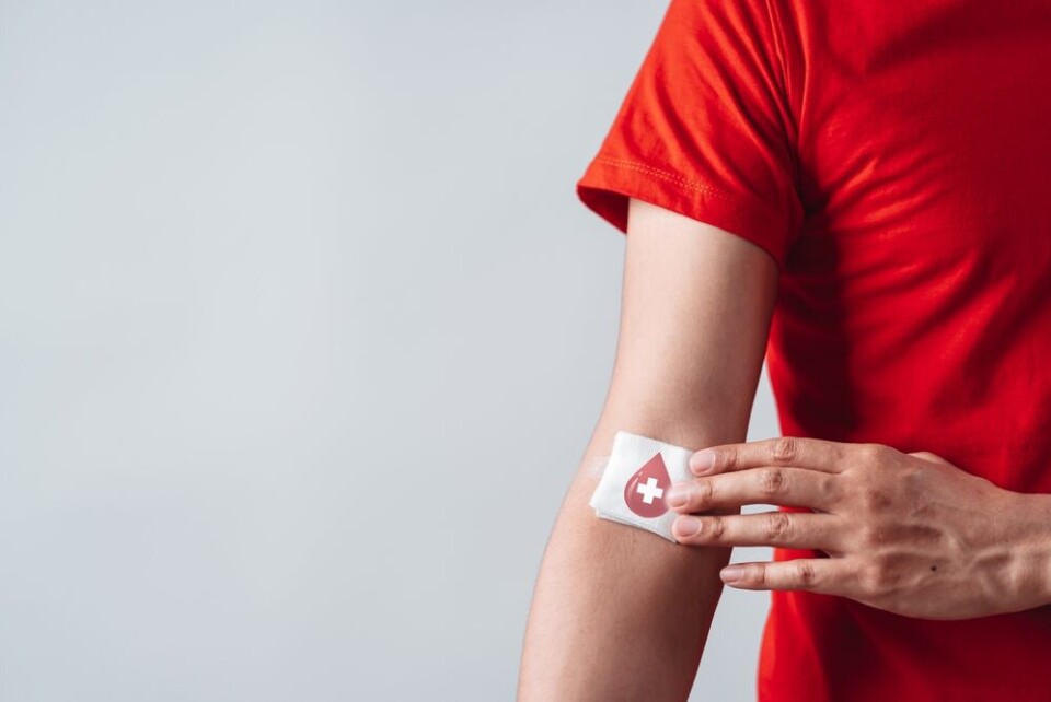 Man showing plaster after blood donation