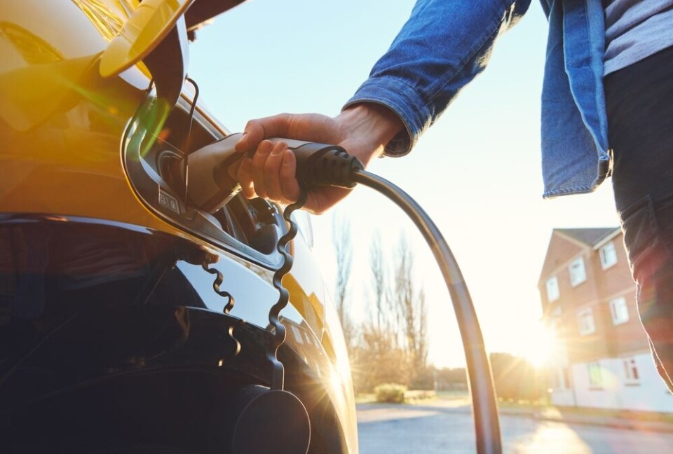 A man plugging in his electric car