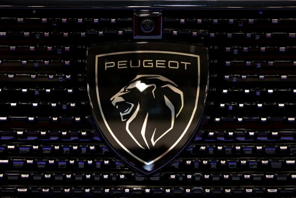 A view of the new Peugeot logo on the front of a car