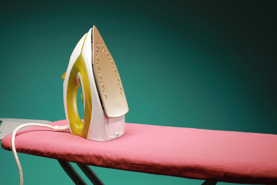 Nazar Skladanyi / Shutterstock A view of an iron on a red ironing board