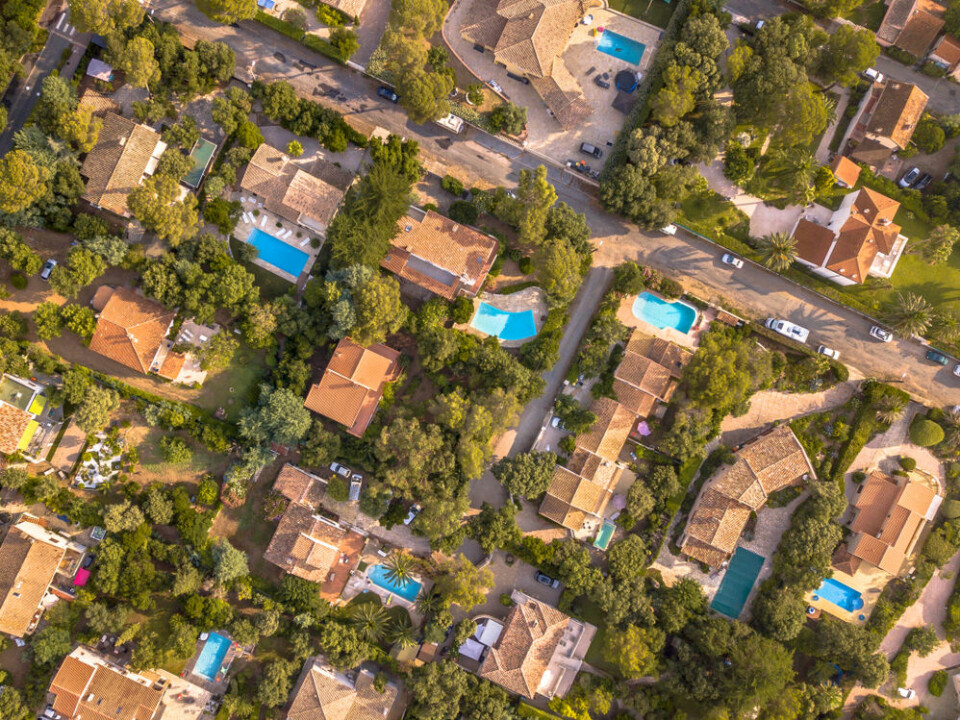 An aerial view of villas with swimming pools in the south of France (image for illustration only)