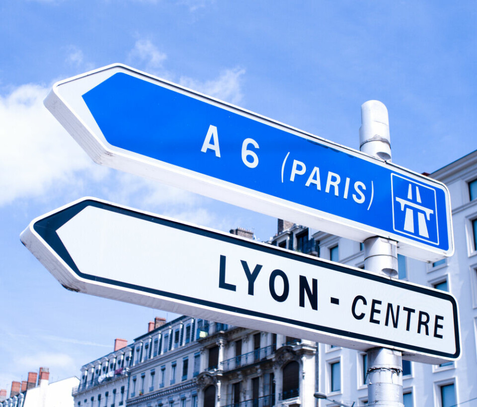 A view of a road sign saying Paris and Lyon - Centre