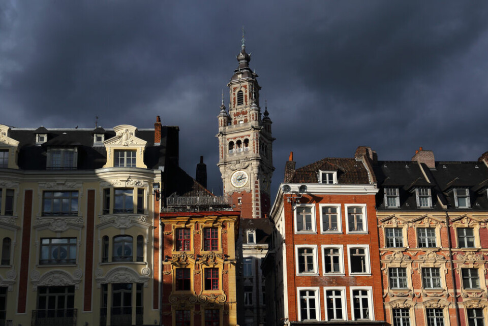 Dark rainclouds above the clock tower of the stock exchange building in Lille