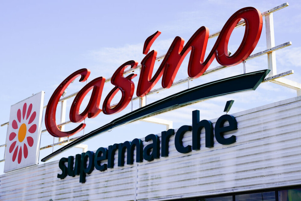 A view of a Casino logo sign on a supermarket roof