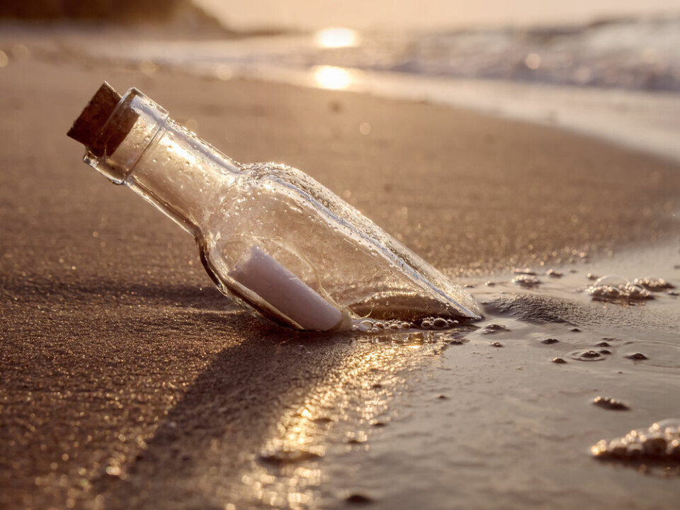 A bottle with a letter inside, washed up on a beach