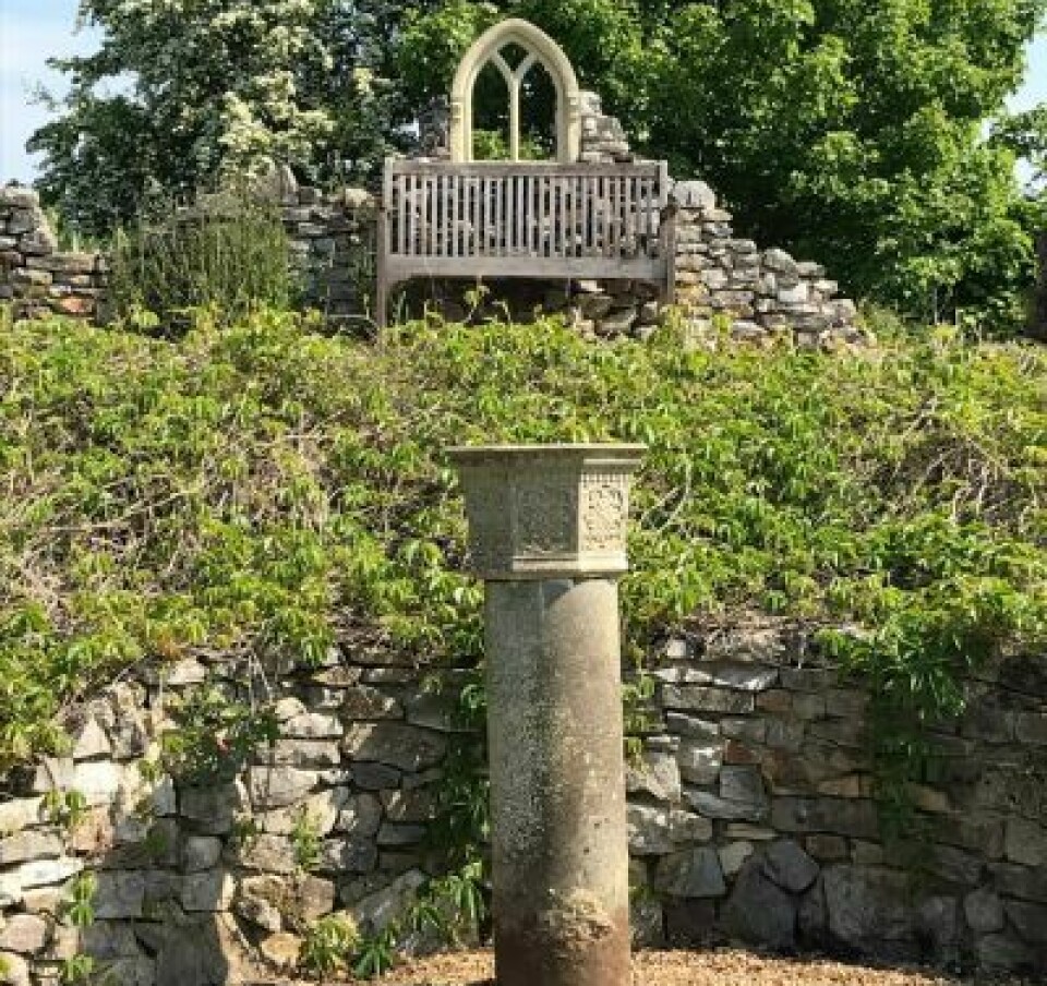 Stone plinth in summer garden